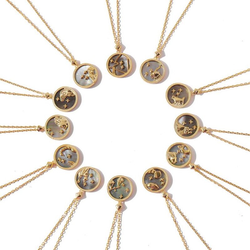 Gold necklaces with zodiac constellations on a white background